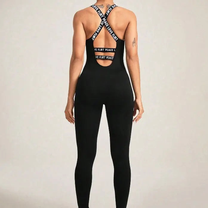 Back view of a black seamless camisole jumpsuit with crisscross elastic straps and cutout detail, fitted and stretchy for a snug silhouette