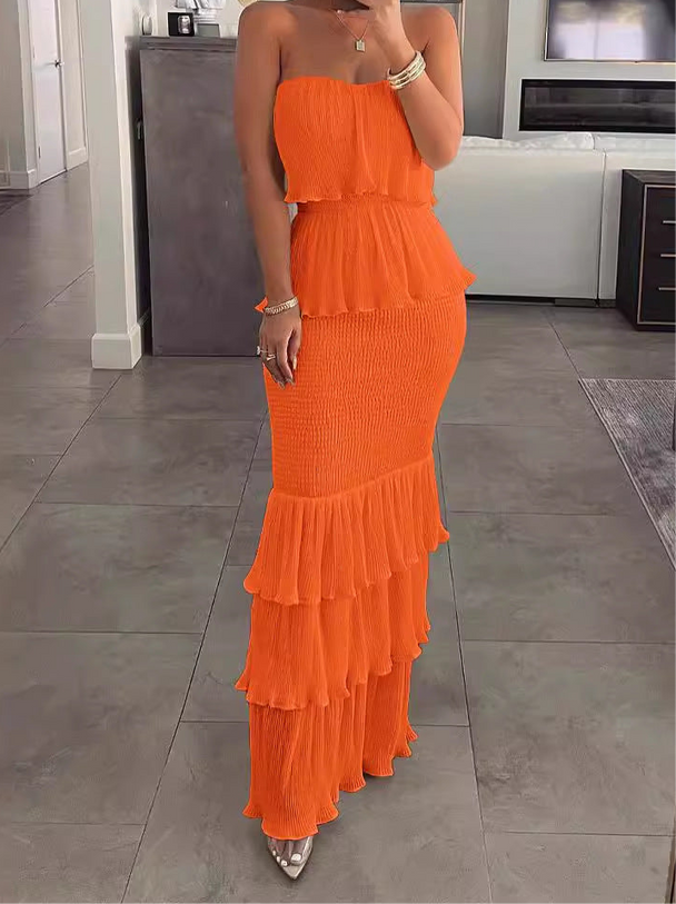 Strapless ruffle maxi dress in orange, featuring a flowy, elegant design for evenings out.