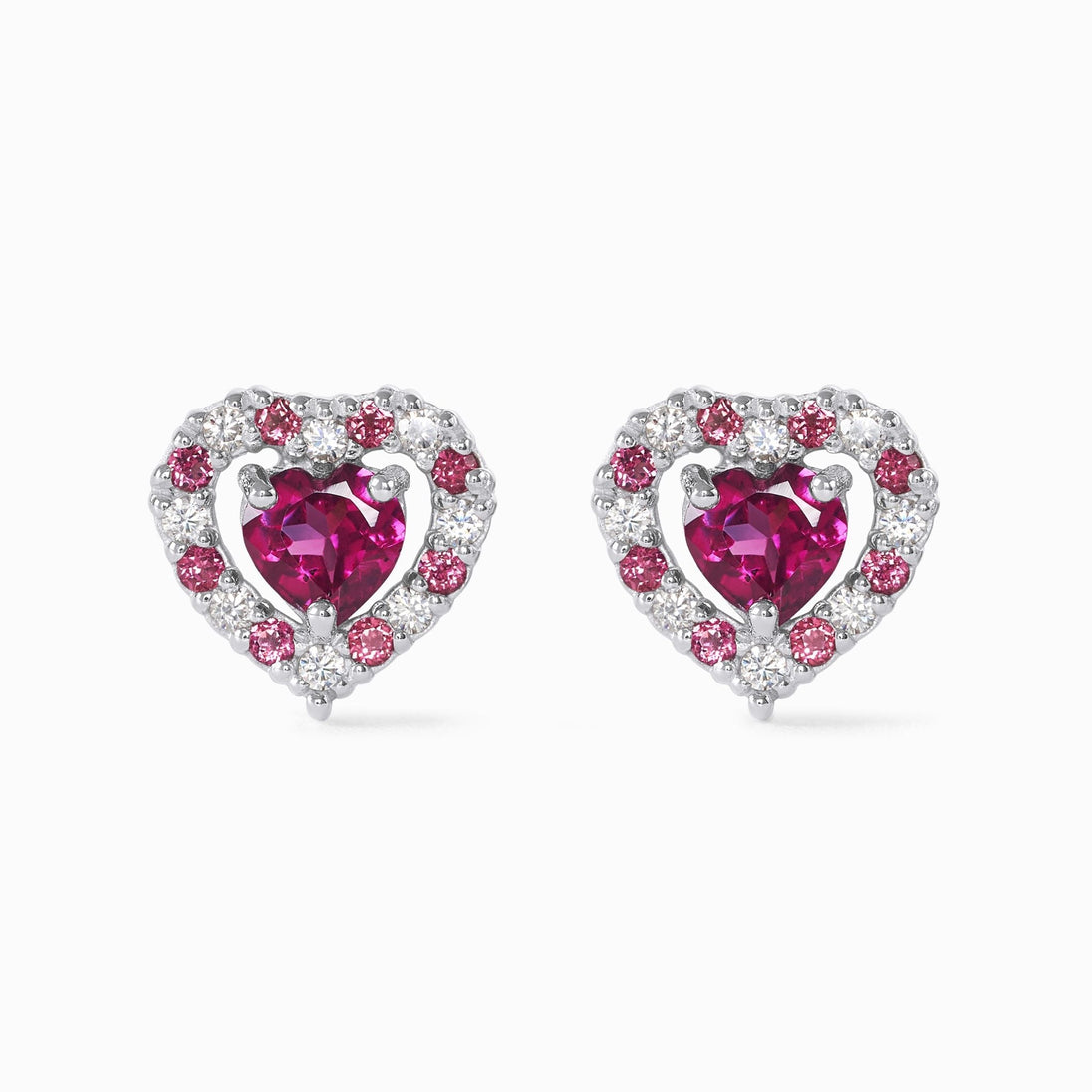 Close-up of red heart rhodolite garnet stud earrings with sterling silver and simulated diamonds