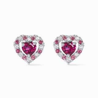 Close-up of red heart rhodolite garnet stud earrings with sterling silver and simulated diamonds