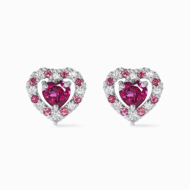 Close-up of red heart rhodolite garnet stud earrings with sterling silver and simulated diamonds