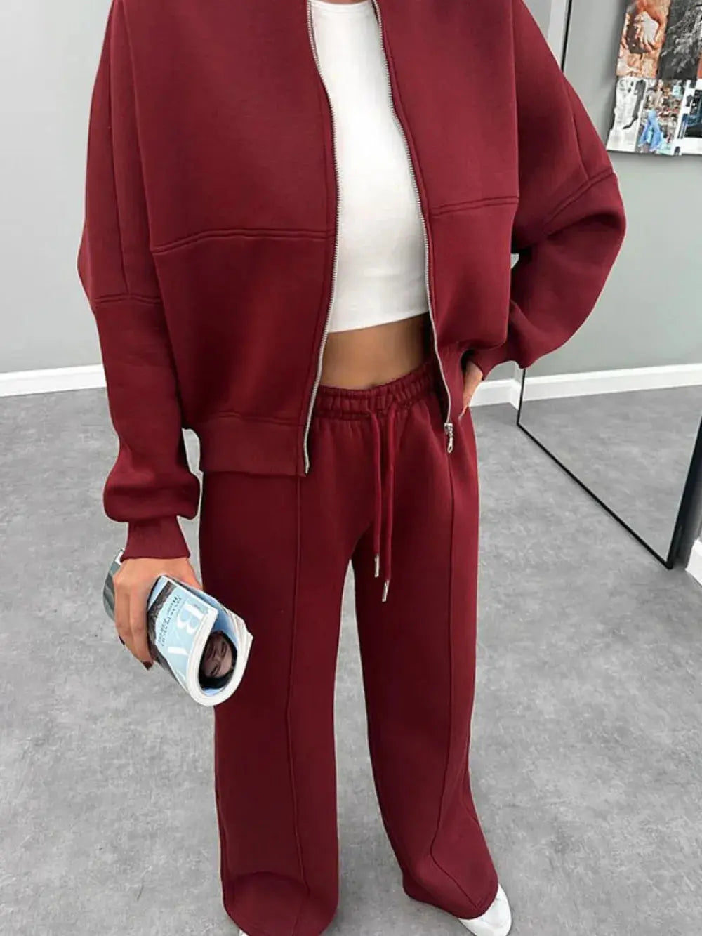 Women's maroon baseball collar zip up outerwear and drawstring pants set with white crop top and white sneakers