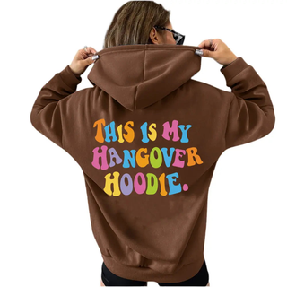 Women’s oversized brown hoodie with colorful "THIS IS MY HANGOVER HOODIE" back print and drop shoulder design