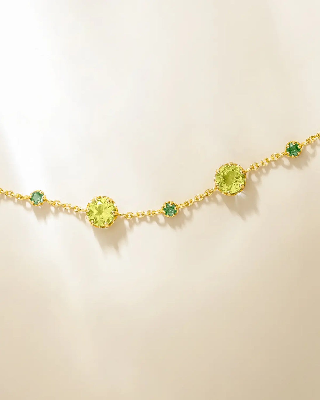 Emerald and peridot bracelet in 18k gold vermeil with round cut gemstones on adjustable chain