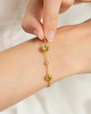 Handcrafted emerald and peridot bracelet in 18k gold vermeil on wrist, part of Emerald & Peridot Jewellery Set