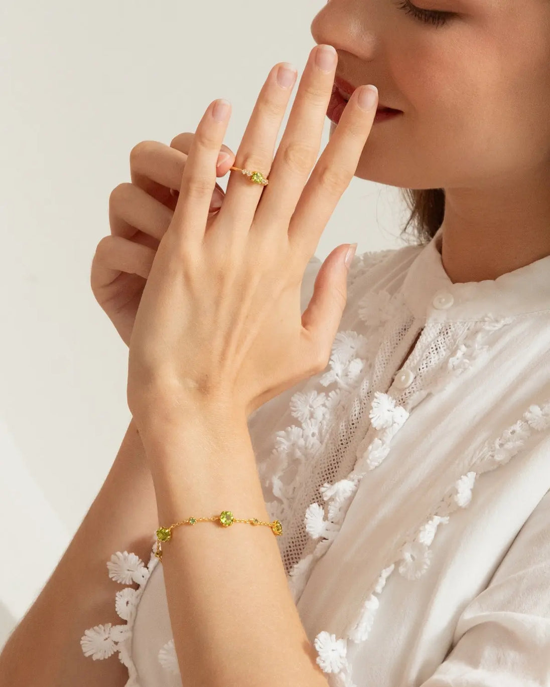 Elegant Emerald & Peridot Bracelet in 18k gold vermeil on wrist, showcasing natural green gemstones and delicate design