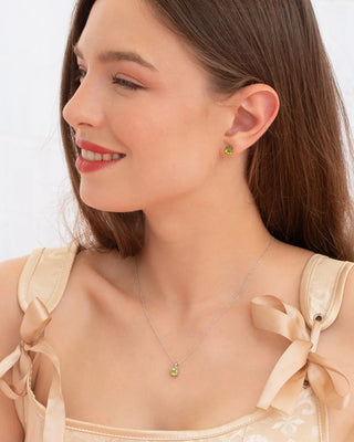 Woman wearing peridot everyday jewellery set with sterling silver necklace and stud earrings