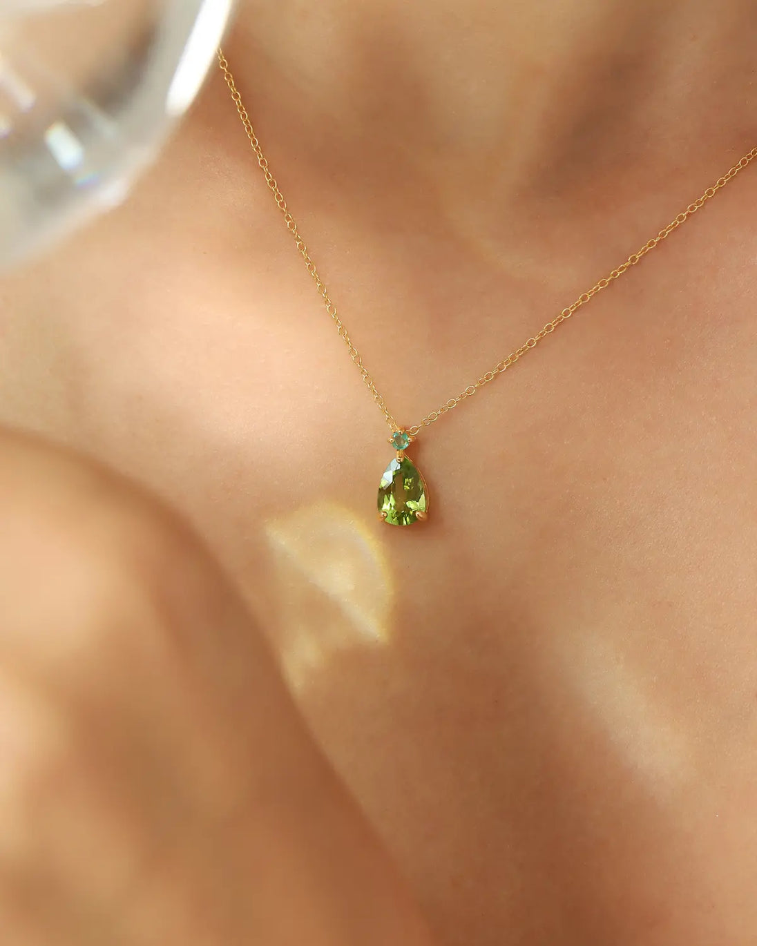 Emerald & Peridot pear cut pendant necklace in 18k gold vermeil on model's neck