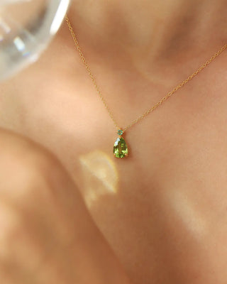 Emerald & Peridot pear cut pendant necklace in 18k gold vermeil on model's neck