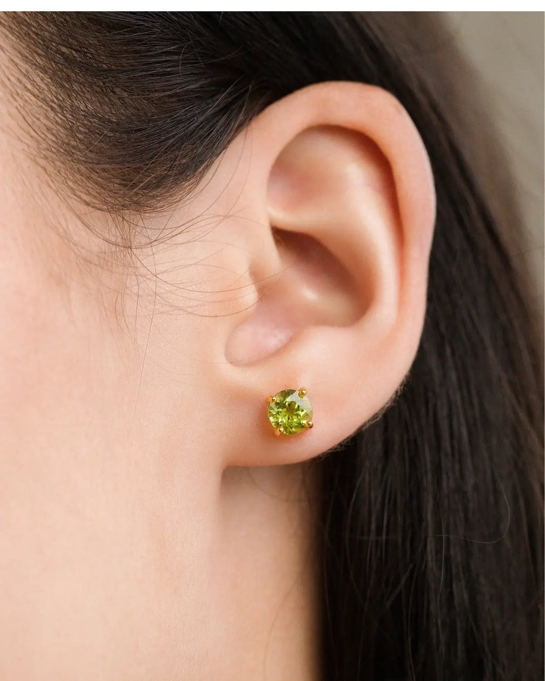 Close-up of green peridot stud earring from Emerald & Peridot Jewellery Set in 18k gold vermeil