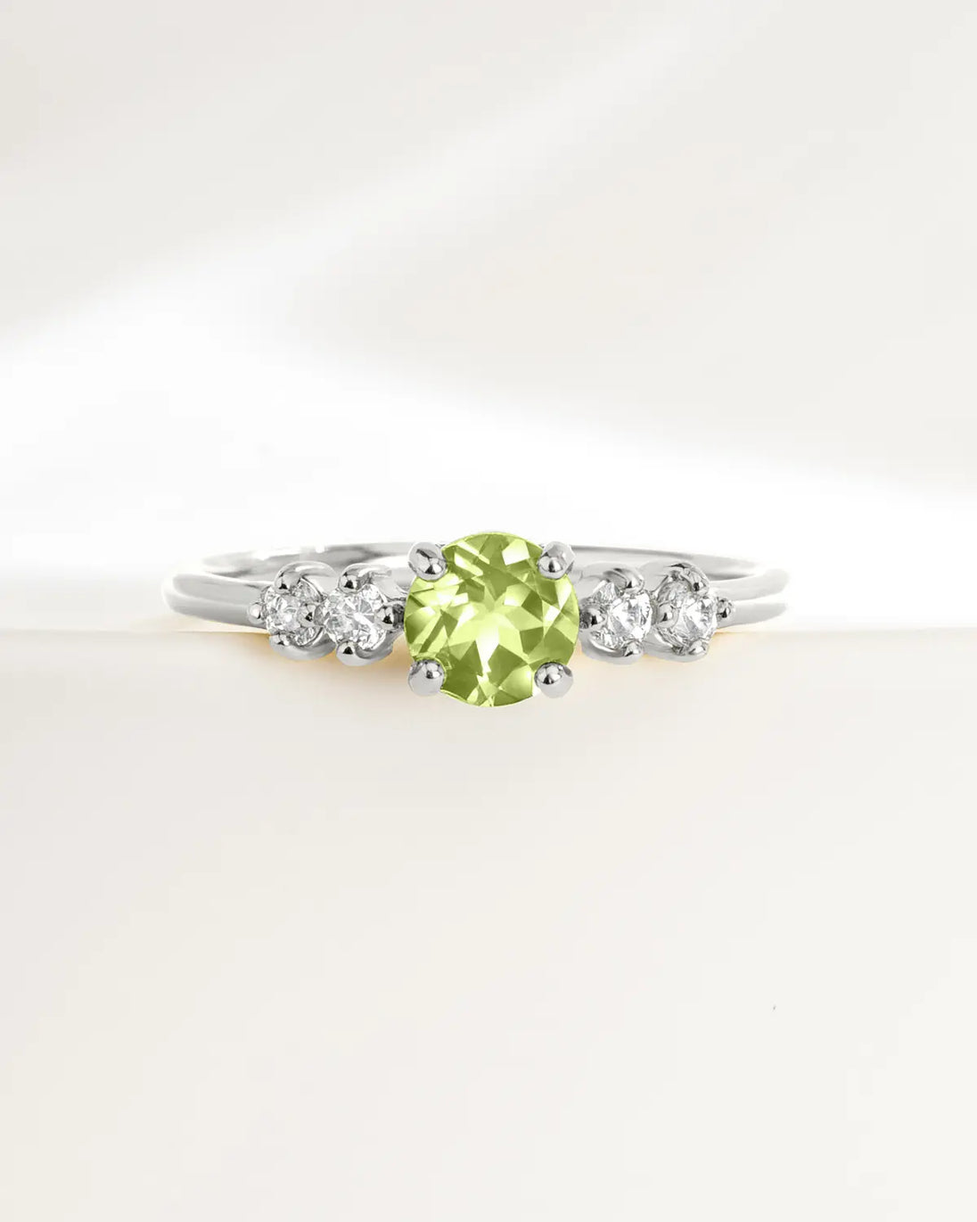 Sterling silver peridot ring with round cut green gemstone and small simulated diamonds for everyday wear