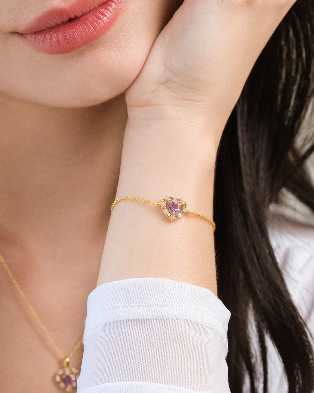 Close-up of a woman's wrist wearing a purple heart lavender amethyst bracelet in 18k gold vermeil