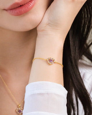 Close-up of a woman's wrist wearing a purple heart lavender amethyst bracelet in 18k gold vermeil