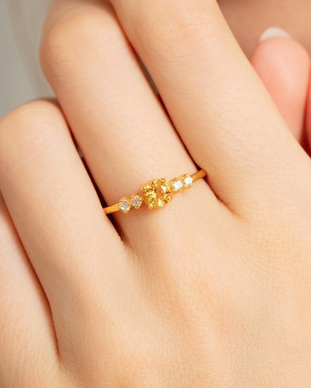 Citrine five stone ring with natural citrine and simulated diamonds in 18k gold vermeil on hand.