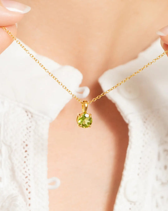 Peridot everyday jewellery set featuring 18k gold vermeil necklace with round cut green peridot pendant.