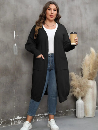 plus size long sleeve black pocketed cardigan worn with jeans and white sneakers