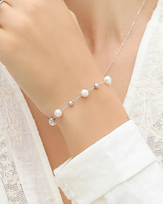 Pearl bracelet with natural freshwater pearls and sterling silver beads on adjustable chain worn on wrist