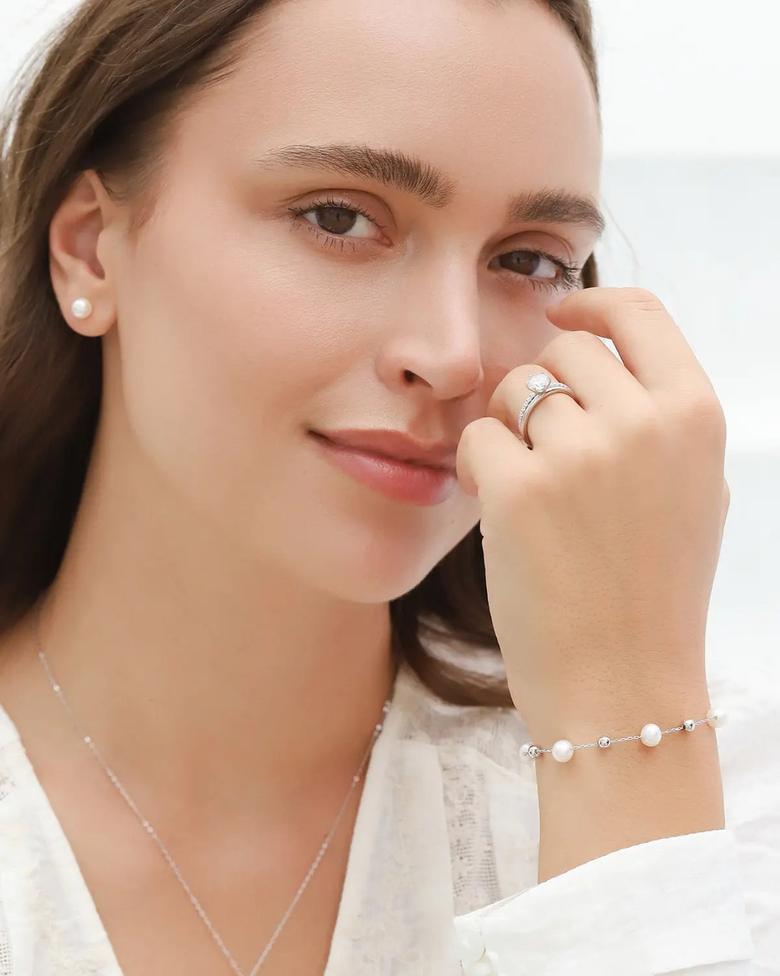 Pearl bracelet with natural freshwater pearls and sterling silver balls on adjustable rhodium-plated chain worn by woman