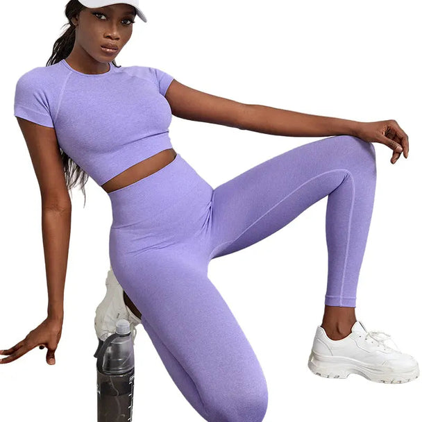 woman wearing purple quick-dry workout outfit with high-waist yoga pants and matching top