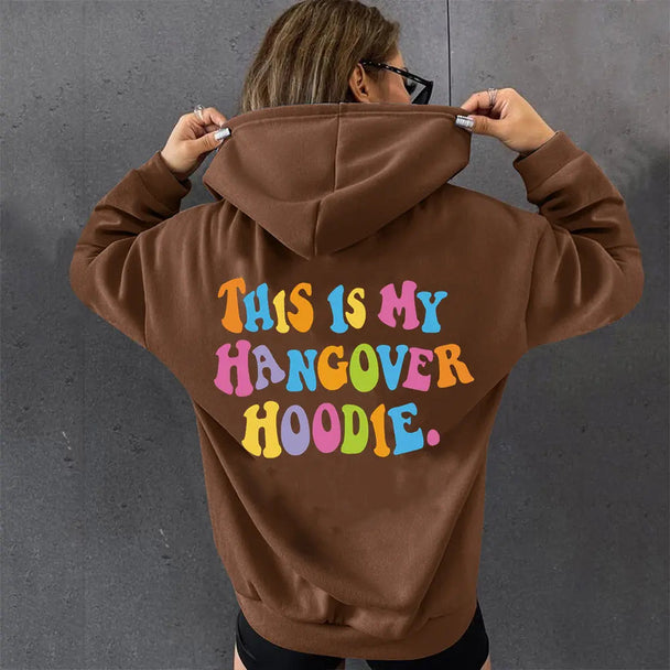 Women’s oversized brown hoodie with colorful "THIS IS MY HANGOVER HOODIE" back print and drop shoulder design