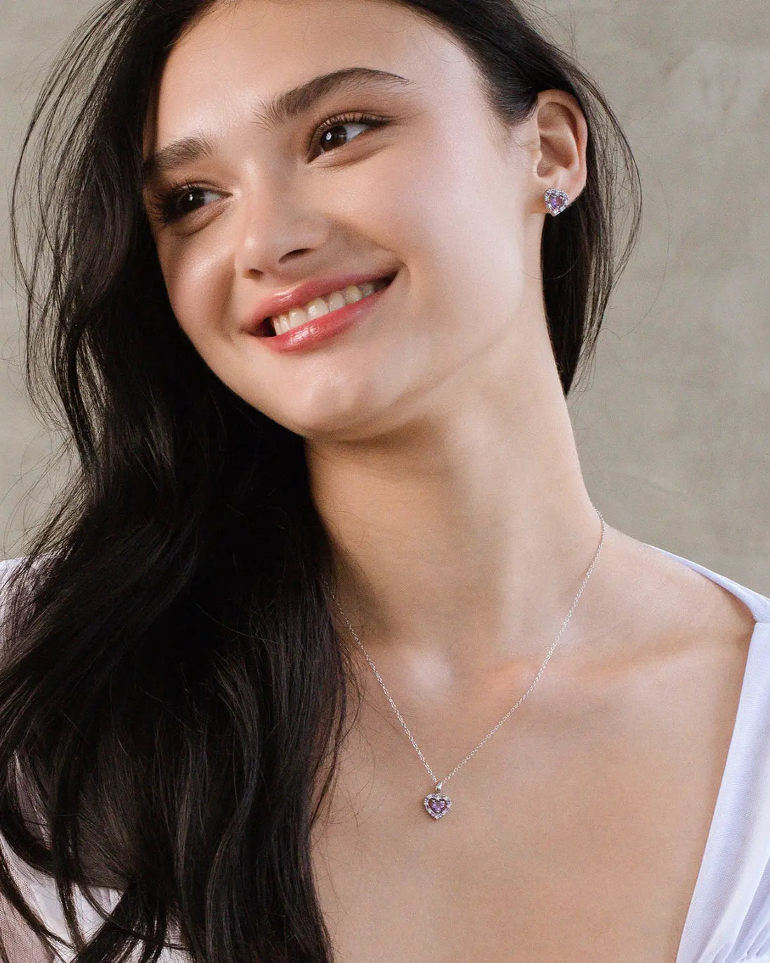 Woman wearing purple heart lavender amethyst pendant necklace and stud earrings in sterling silver