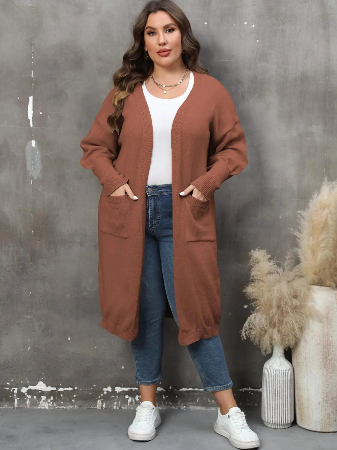 plus size long sleeve rust brown pocketed cardigan with open front ribbed design worn with white top and jeans