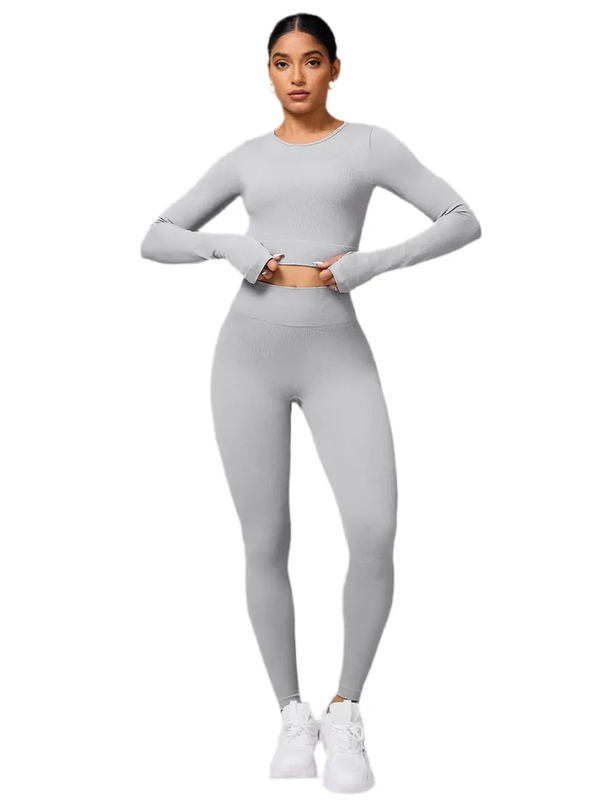 woman wearing gray back crisscross long sleeve top and leggings active set
