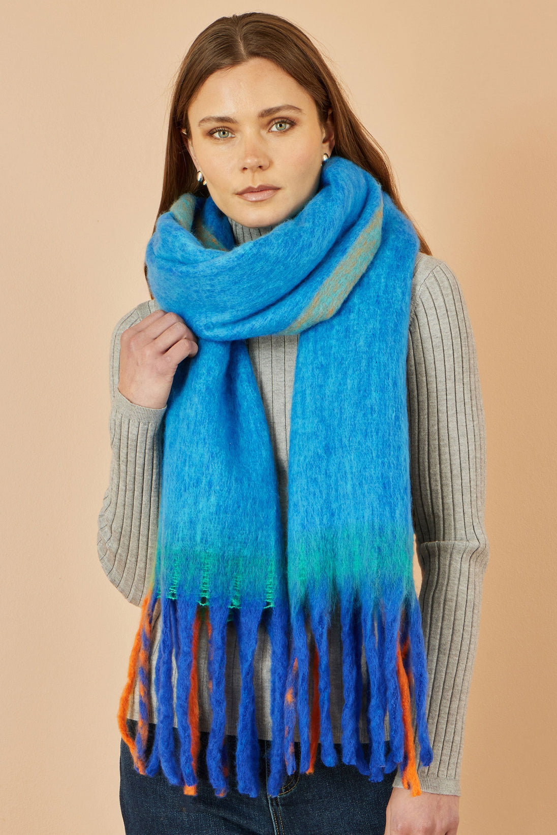 Woman wearing Yumi Blue Colour Block Scarf in vibrant blue with green and orange accents