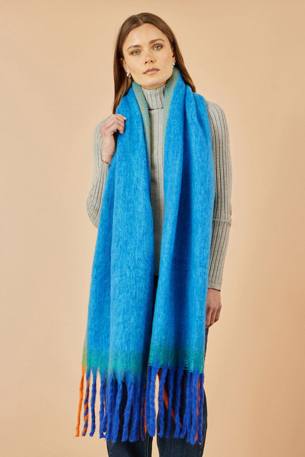 Woman wearing Yumi Blue Colour Block Scarf made of 100% polyester with fringe details