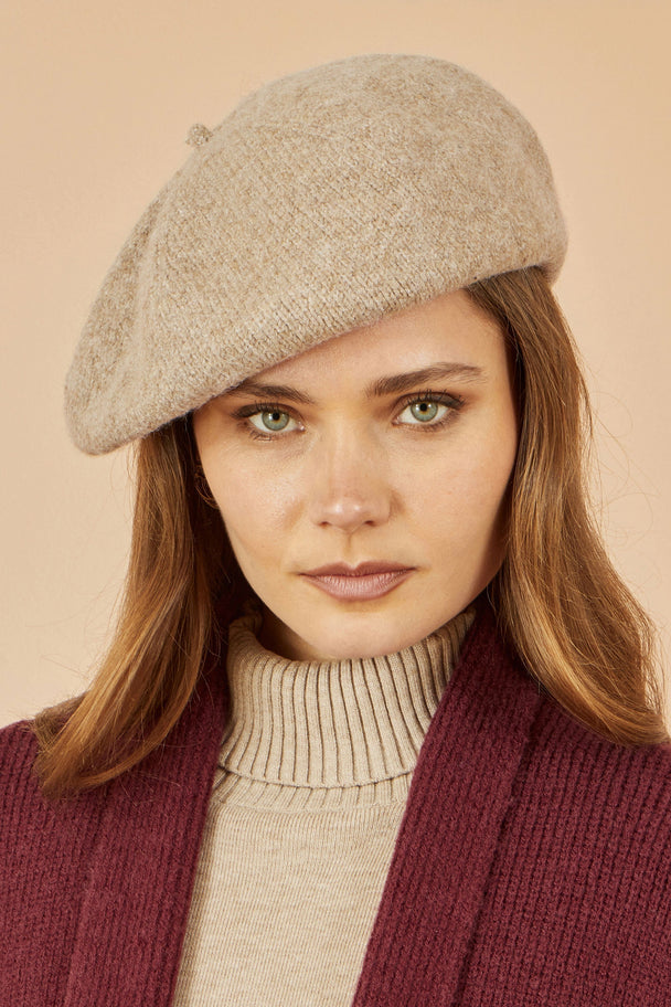 Yumi Oatmeal Soft Knitted Beret worn by woman with long brown hair and neutral makeup