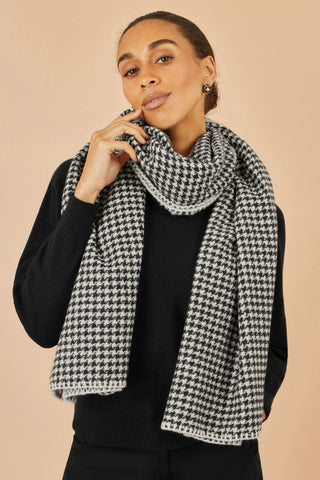 Yumi Black Dog Tooth Scarf with stitch detail worn by woman