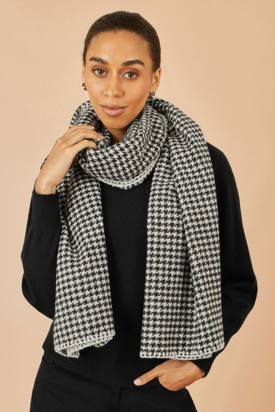 Yumi Black Dog Tooth Scarf with stitch detail on woman wearing black sweater
