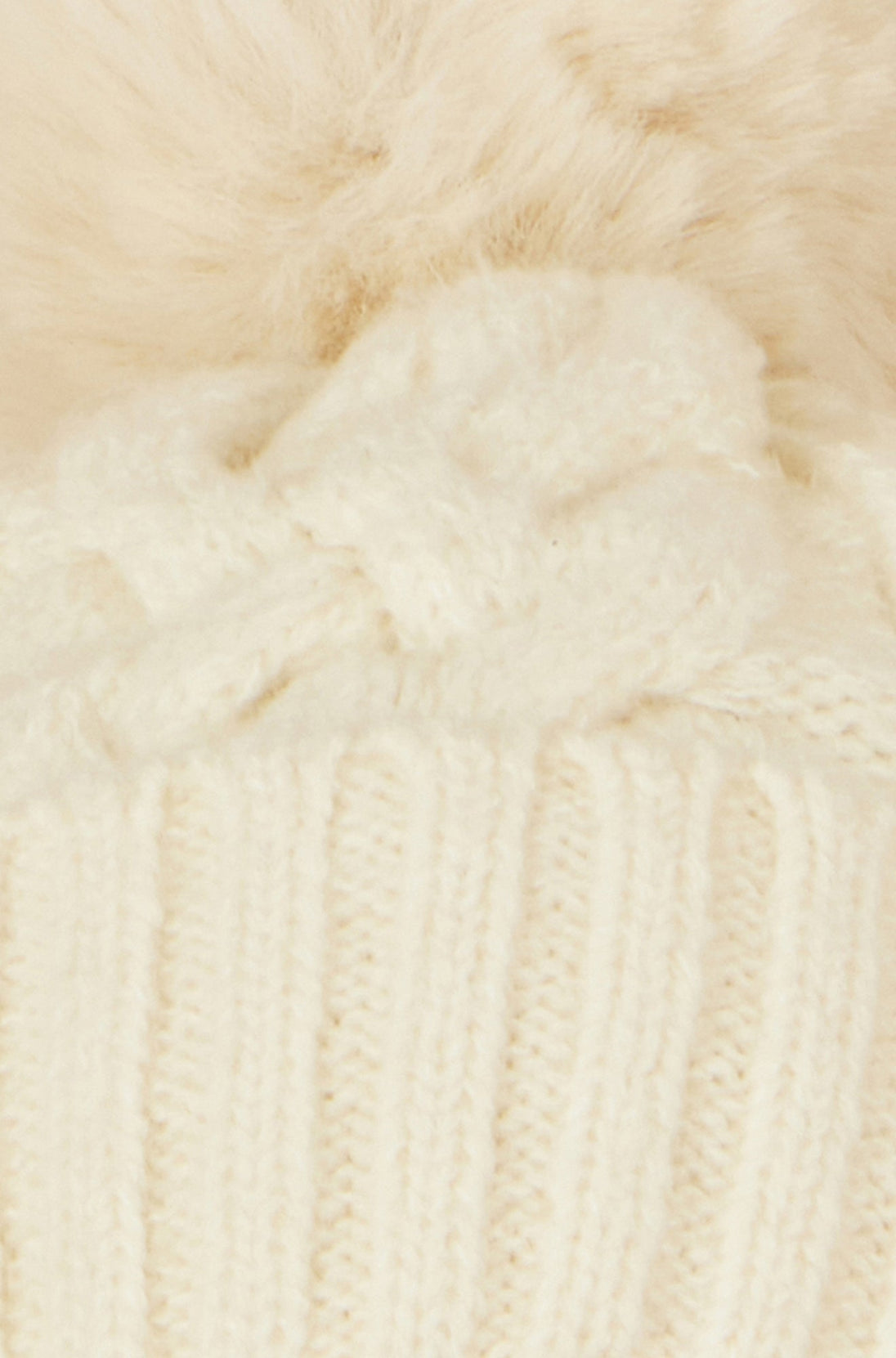 Yumi white cable knit bobble hat made of 100% nylon with hand wash care