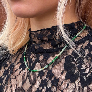 Milos Mixed Gemstone Beaded Necklace with Prehnite, Moss Agate, and Green Aventurine on 22K gold recycled brass worn on lace top