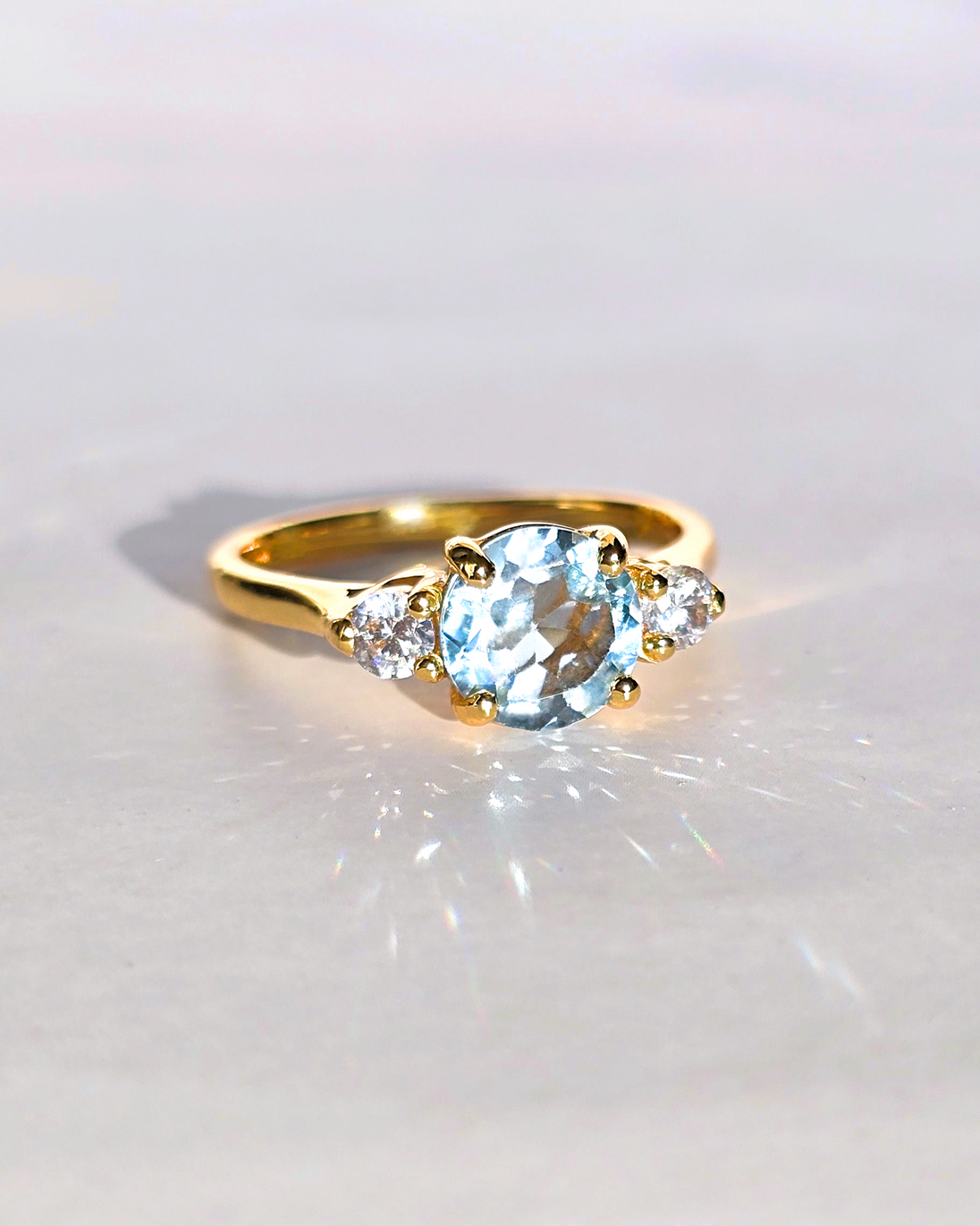 Blue Topaz Three Stone Ring with sky blue topaz and simulated diamonds in 18k gold vermeil