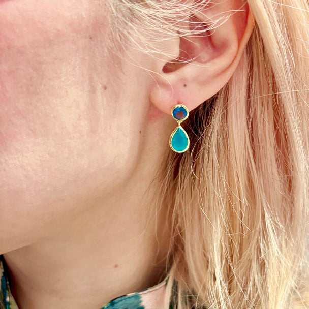 Gold double gemstone drop earrings with Pariba Onyx and Hydro Iolite on a woman's ear, 22K gold on recycled brass, 24mm length