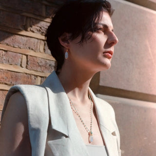 Persephone Double Gemstone necklace with moonstone and amazonite beads on gold chain, worn by woman in natural light