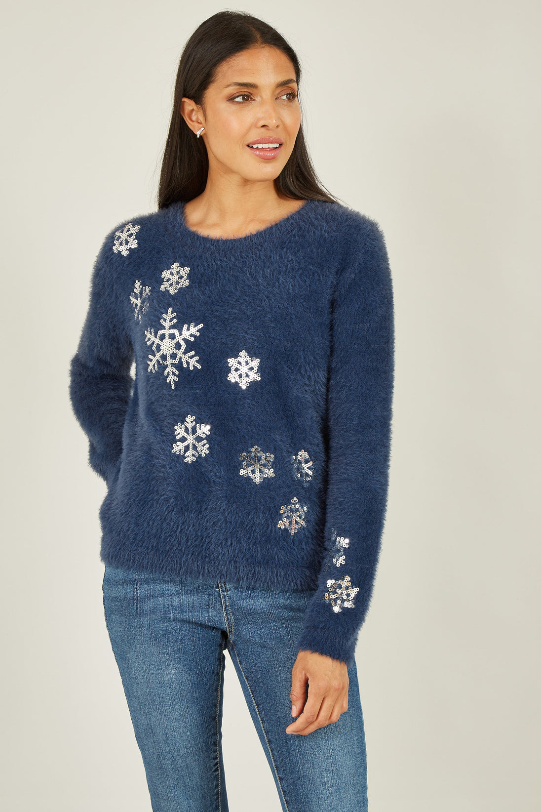 Woman wearing navy sequin snowflake fluffy jumper with silver snowflake embellishments