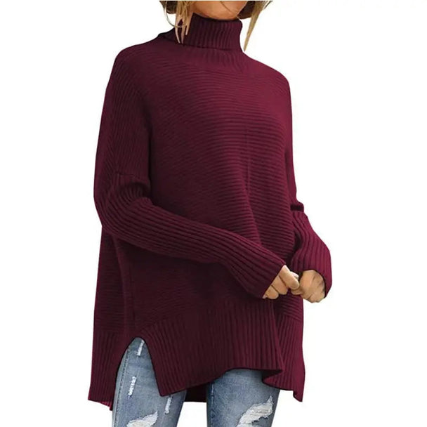 Burgundy oversized turtleneck batwing sleeve sweater with ribbed texture and tunic length.