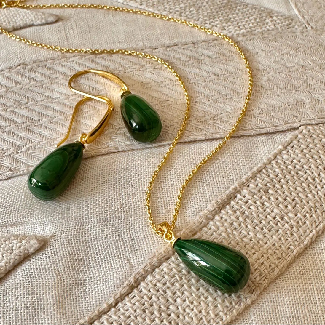 Hera polished stone pendant necklace with pear-shaped malachite on 22k gold brass chain and matching earrings