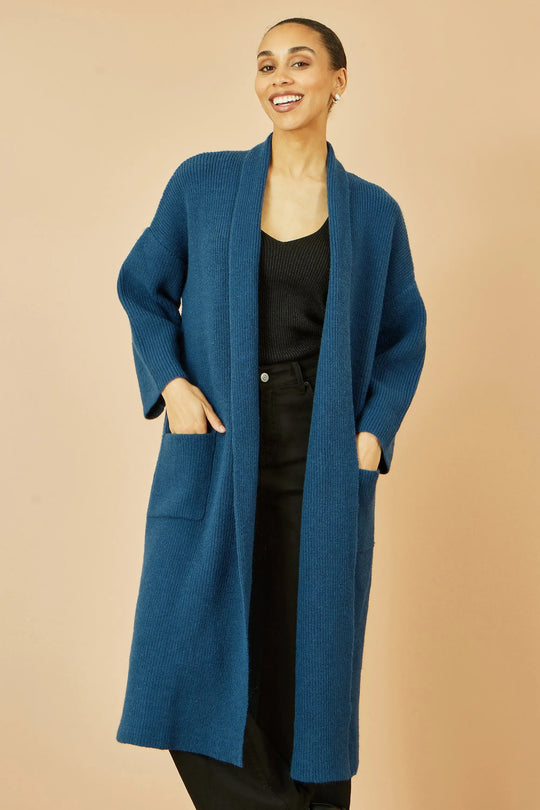 Yumi Teal Knitted Maxi Cardigan with pockets and vertical ribbed detail worn by smiling woman