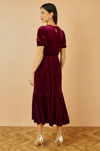 Yumi Burgundy Velvet Midi Dress with V neckline, tiered skirt, and pockets in deep burgundy velvet