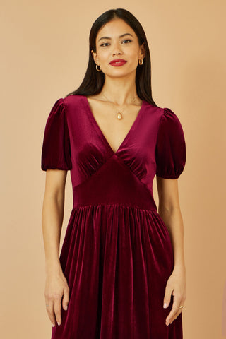Yumi Burgundy Velvet Midi Dress with V neckline and tiered skirt in deep burgundy velvet
