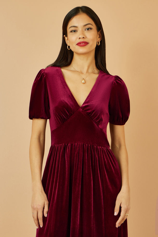 Yumi Burgundy Velvet Midi Dress with V neckline and tiered skirt in deep burgundy velvet