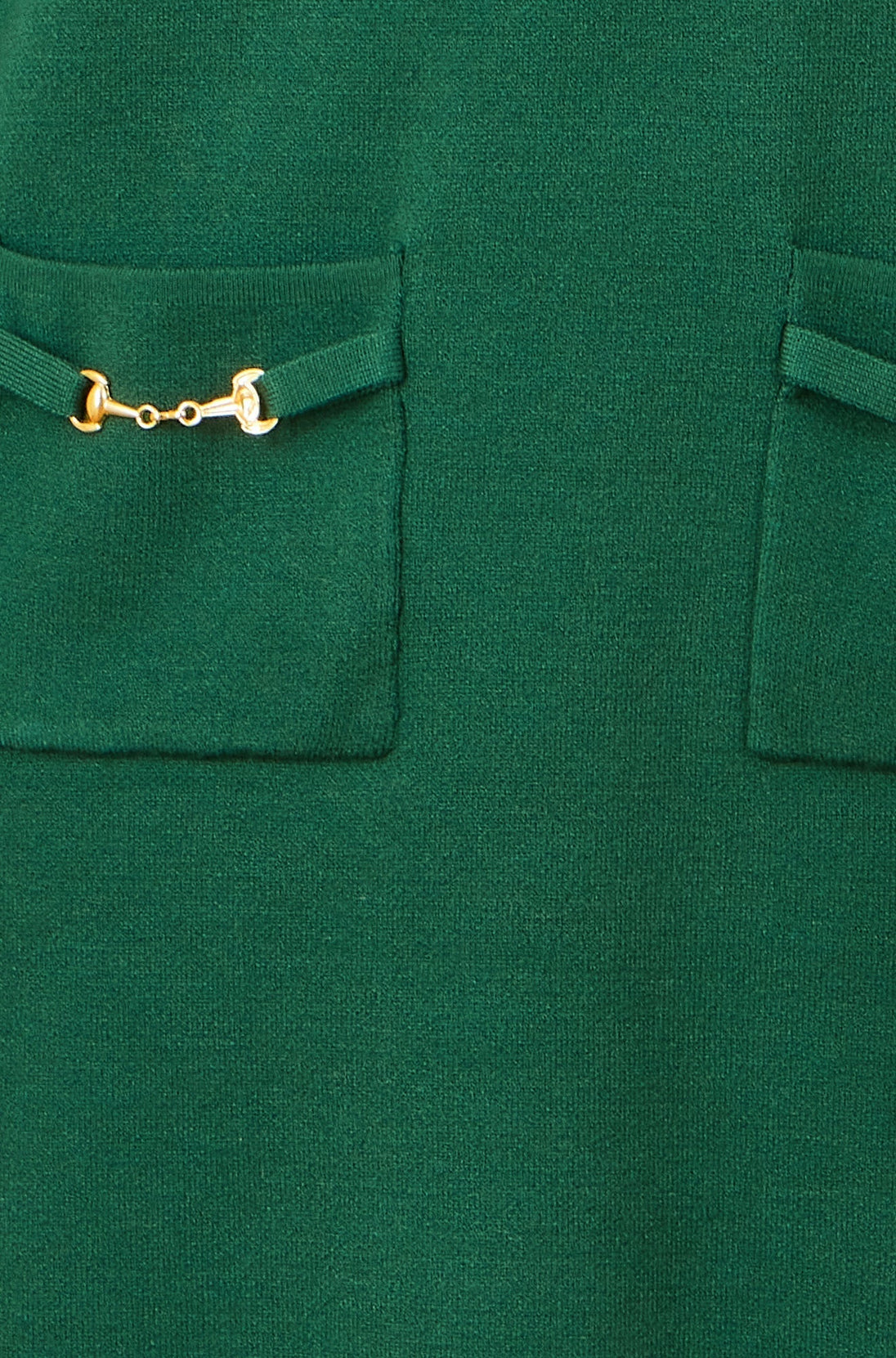 Close-up of Yumi green knitted tunic dress pocket with gold snaffle hardware detail