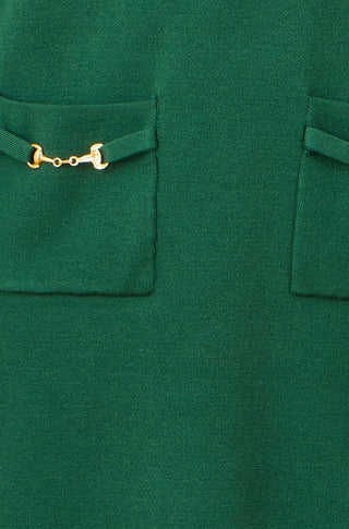Close-up of Yumi green knitted tunic dress pocket with gold snaffle hardware detail