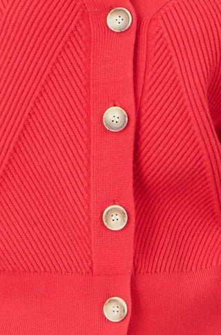 Close-up of Yumi red relaxed fit cardigan with button-up design and stitch detail