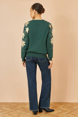 Yumi green relaxed fit jumper with sequin star sleeves back view on model