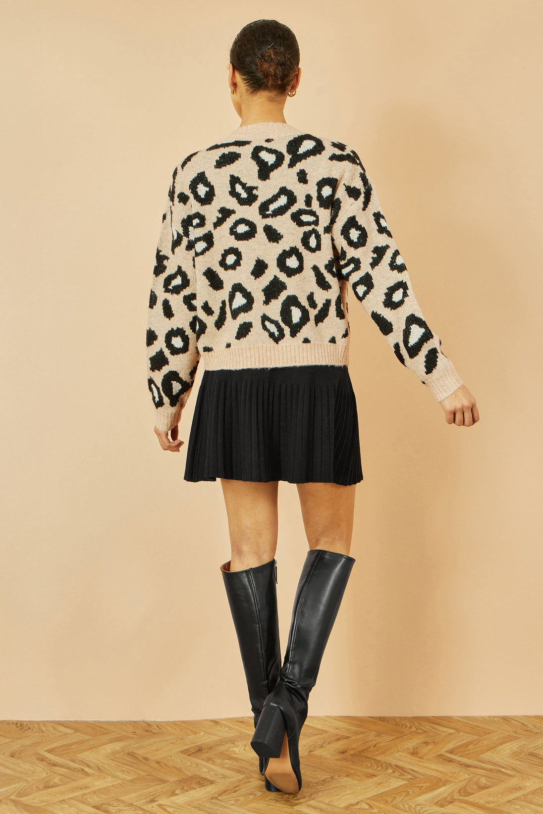 Yumi Beige Animal Print tie front intarsia knit cardigan worn with black skirt and boots