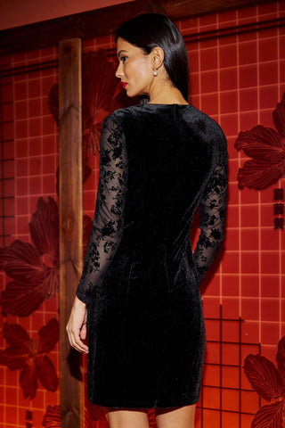Black fitted velvet dress with sheer floral long sleeves, elegant mini dress style
